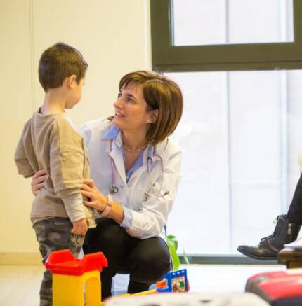 Η παιδίατρος με παιδί και γονέα σε παιδικό ιατρείο κατά τη διάρκεια εξέτασης